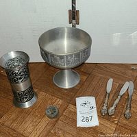Photo showing pewter goblet, pewter vase, one coin, and butter knives (not included)