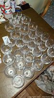 Wide view showing all 36 stemware glasses arranged closely on a table, highlighting the variety of glass sizes and shapes.