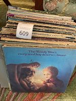 Image showing large stack of vinyl records with The Moody Blues album as the foremost record.