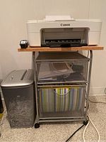 Side view of Canon printer on top of the metal wire organizational cart with shredder beside it, showing complete layout of lot items