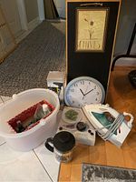 Photo showing quartz clock, Rowenta iron, Terraillon scale, ironing board and other kitchen items