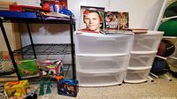 Photo showing two 3-drawer plastic organizer bins and one black metal 2-tier wire shelf. Various items around but not included.