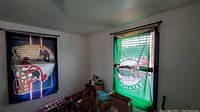 Two flags hung in a corner of a room, one Patriots and one Celtics