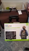 Brown soft-sided Rolling Boots & Barkley pet carrier positioned upright showing handle and front mesh ventilation pocket.