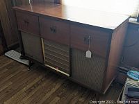 Full view of walnut-finish console cabinet and speaker grills.