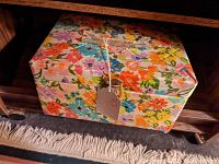 Full view of the vintage sewing box with multi-color floral fabric covering and the tag showing the price.
