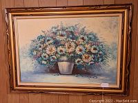 Front view of framed acrylic oil painting of blue daisies in pot by Robin, showing the whole artwork and frame.