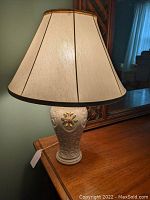 Full view of Belleek porcelain table lamp with cream fabric shade and gold trim