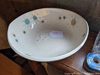 Starburst pattern 12-inch oval salad bowl, side angled view showing pattern and shape.