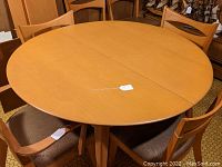 Overhead view of assembled round table with center seam and tag on top