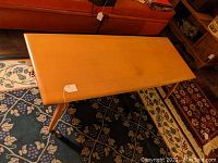 Angled overview of table showing top surface and legs