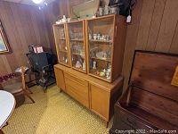Front view of two-piece china hutch showing top glass cabinets and bottom drawers