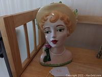 Front view of ceramic limited edition Marie Osmond head vase bust, showing painted face and pearl necklace.