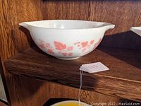 Side view showing the pink Gooseberry pattern on white glass with dual pouring spouts.