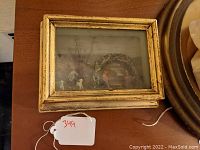 Front view of shadowbox diorama showing religious nativity scene with figures and gold frame.