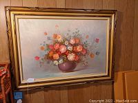 Full view of the framed oil painting showing the floral arrangement in a vase.