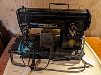 Front side view showing entire Singer Model 301 sewing machine with foot pedal and power cord attached.