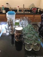 Photo showing all glassware items including mason jars, glasses, pitcher, carafe, and baking dishes on kitchen countertop