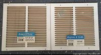 Two 12x12 inch white plastic vent covers labeled Ameriflow and Register & Grills.