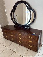 Front and side view of Henredon wood veneer dresser with matching mirror