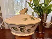 Side view of vintage Fitz & Floyd Sommer Hill Pear large oval casserole with lid featuring 3D pear handle and leaf decoration