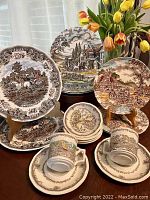 Photo showing entire lot with variety of plates, cups, saucers and bowls featuring vintage transferware patterns.