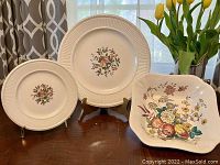 Front view showing Wedgwood Conway round platter and plate with floral center and ribbed edges, and Spode Gainsborough square floral serving bowl