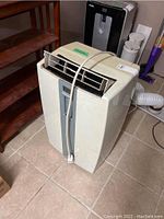 Front view of Premiere portable air conditioner showing air vent and control panel with attached power cord.