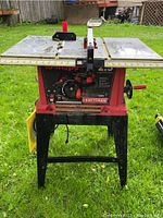 Front view of Craftsman table saw showing work surface, adjustment handles, and legs.