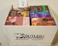 Box full of 50 paperback romance books, showing colorful cover art with romantic themes.