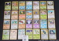 Front view of the first 30 Pokémon cards laid out in rows showing various Pokémon characters and their details