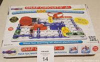 Closed box of Snap Circuits Jr. SC-100 kit showing front label highlighting over 100 projects, for ages 8-108