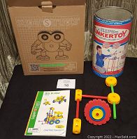 Photo of vintage Tinker Toy set in original tin can and Super Structs boxed construction toy set with parts and instruction manual.