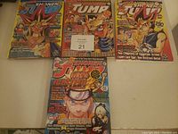 Four Shonen Jump comic books laid out on a flat surface featuring covers with characters from Yu-Gi-Oh! and Naruto series.