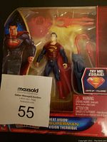 Front view of boxed Heat Vision Superman figure showing figure, accessories, and packaging details.