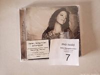 Photo of the Sarah McLachlan Afterglow CD showing front cover with promotional sticker for the single 'Fallen'.