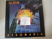 Front cover of Def Leppard Pyromania album with distinct exploding target artwork and minimal wear.
