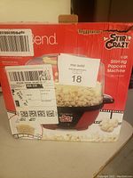 Box displaying the brand and model of the popcorn machine, showing it is an 8 quart Stir Crazy model by West Bend.