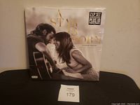 Front cover of A Star Is Born vinyl record set shrink-wrapped with sticker showing 2LP set and booklet.