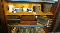 Wooden crate, boxes on shelf with ceramic planters, cups, and bowls