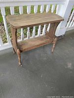 Full view of vintage wood shelf showing rectangular top and turned legs