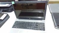 Front view of the HP laptop with screen open showing black keyboard and 15 inch display