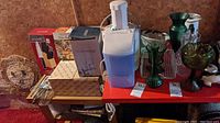 Wide view showing juicer, boxed Oneida beer glasses, whisks, and other kitchen items.