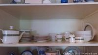 Wide shelf photo showing complete Royal Doulton Rondalay set with plates, bowls, cups, and serving pieces arranged neatly.
