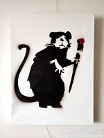 Full frontal photo of the stencil art on white canvas showing the rat holding a paintbrush with red paint.