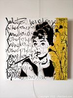 Front view of square canvas showing full stencil portrait, script overlay and yellow splatter area