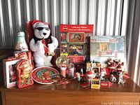 Full lot of Coca-Cola Christmas collectibles including tins, plush, figurines, plates, and snow globe