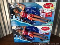 Photo of two Barbie dolls in original Coca-Cola Splash packaging, showing overall condition and included accessories