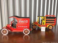 Two Coca-Cola delivery truck models side by side showing details and size
