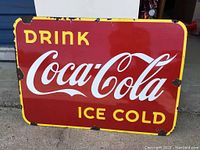 Front view of porcelain sign showing full 'Drink Coca-Cola Ice Cold' design